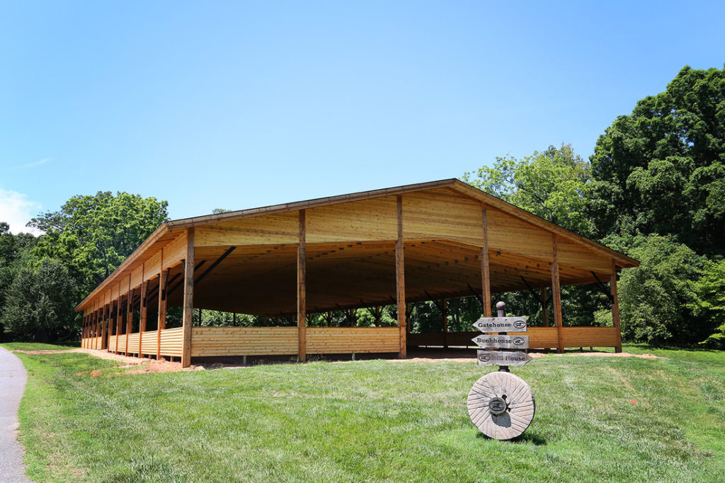 Wooden Pole Barn Riding Arena With Exposed Scissor Trusses