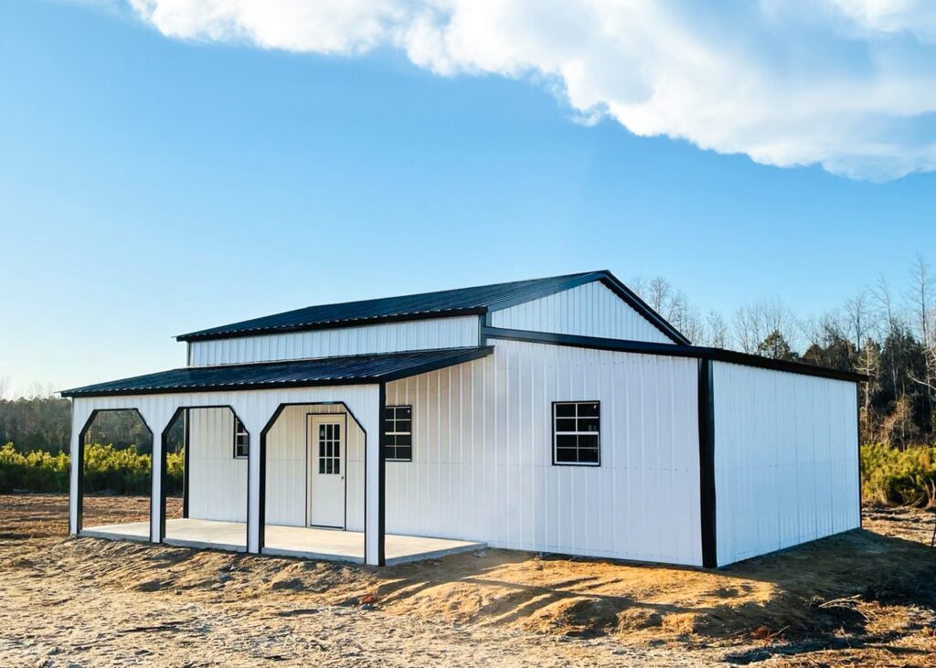 A while metal building with black trim and roof